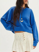 Vibrant royal blue cropped sweatshirt with dropped shoulder and exposed seam detail featuring ribbed cuffs designed for machine wash cold