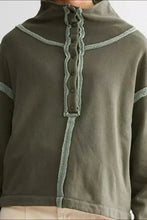 Exposed seam half snap long sleeve sweatshirt in olive green with light green stitching