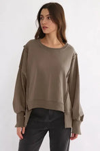 Olive green exposed seam long sleeve sweatshirt with high-low hem