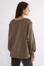 Exposed seam olive green long sleeve sweatshirt with cuffed sleeves