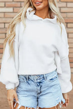 Exposed seam long sleeve hoodie with white oversized style and distressed denim shorts