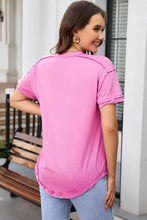 Woman in pink short-sleeve Exposed Seam Quarter-Button Tee with dropped shoulders and light blue jeans