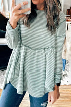 Light green waffle knit long-sleeved peplum top with exposed seams, dropped shoulder, and round neck