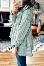 Loose-fitting waffle knit top with exposed seams, dropped shoulder, round neck