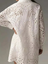 White eyelet button up longline shirt featuring intricate floral and paisley patterns in a lightweight fabric