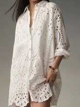 White eyelet button up longline shirt dress with intricate lace cutouts and rolled up sleeves