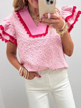 Pink eyelet embroidered flutter sleeve blouse with red ruffled trim and v-neckline in lace fabric