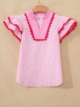 Pink eyelet embroidered flutter sleeve blouse with contrasting bright pink v-neck and red lace trim detailing