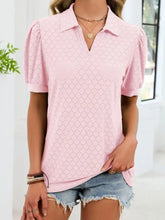 A soft pink eyelet johnny collar puff sleeve top with diamond-patterned eyelet design and short puffed sleeves
