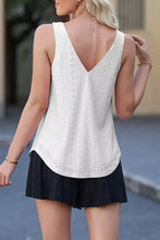 White eyelet knit patterned sleeveless top with loose v neck v-back and curved hemline shown from back side