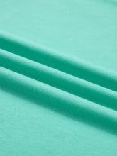 Eyelet lace ruffled cap sleeve top in soft mint green cotton fabric with smooth texture and subtle ribbed weave