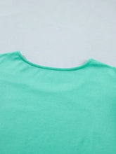 A soft mint green cotton eyelet lace ruffled cap sleeve top with a simple round neckline