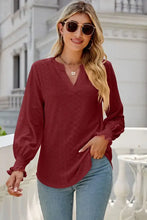 Deep red eyelet notched lantern sleeve V-neck blouse with shirred cuffs