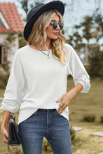 Woman in eyelet round neck long sleeve T-shirt, jeans, hat, sunglasses, necklace