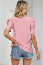 Woman in eyelet round neck puff sleeve T-shirt with short sleeve length