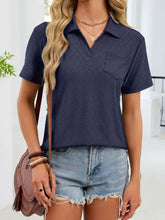 Navy blue eyelet short sleeve blouse with subtle textured pattern and chest pocket for casual or professional wear