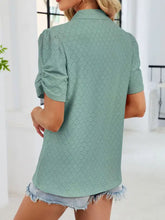 A mint green eyelet short sleeve blouse with collar made of lightweight breathable fabric for casual wear
