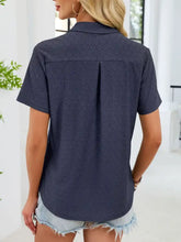 Navy blue eyelet short sleeve blouse with subtle geometric pattern and relaxed fit for casual wear