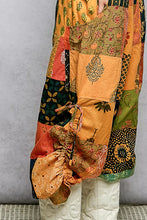 Vibrant pol printed patchwork wide leg pants in orange green and black with assorted patterns and adjustable drawstring hem