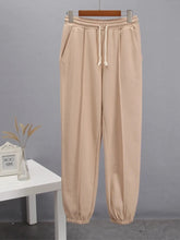 Beige casual drawstring jogger pants with elastic waistband and tapered cuffs for comfortable everyday wear