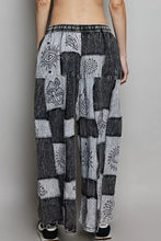 Black and gray patchwork wide leg drawstring pants with embroidered eye flower and mushroom designs from POL