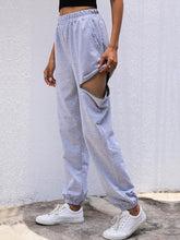 Light gray casual high waist cutout joggers with loose fit and side cutout design featuring care instructions