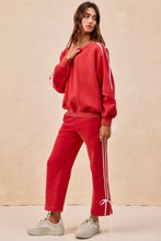 Red fleece sweatpants with white side lined bow details and tied cuffs from bi bi for casual comfort
