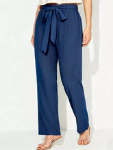 Navy blue high-waisted tied wide leg pants with a self-tie belt and wide leg cut for a stylish fit
