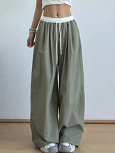 Olive green wide leg drawstring casual pants with a white elastic waistband and matching drawstring for comfort