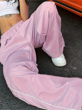 Pastel pink elastic waist wide leg pants with white piping along side seams for stylish comfort and fit