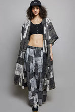 Black and white patchwork denim kimono with intricate eye and floral patterns complements wide leg drawstring patchwork wide pants