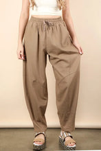 Beige high-waisted solid barrel comfy woven pants with a relaxed tapered fit and subtle side seam detailing