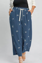 Umgee blue wide-leg pants feature a white embroidered bow pattern and lace drawstring waistband plus size design