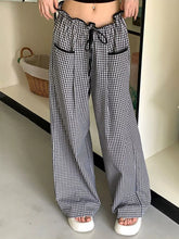 Black and white gingham pattern wide-leg pants with elastic waistband and black drawstring high-waisted gingham pants