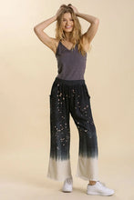 Umgee plus size wide-leg linen blend pants in black and white bleach dip dye with raw hem and frayed detailing