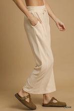 Umgee cream-colored wide leg pants with elastic waistband and side pockets in relaxed fit for comfortable wear