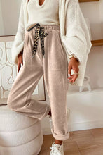 Beige corduroy loose fit pants with a leopard drawstring loose fit tie at the waist for comfortable wear