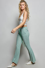 Mint green flared ribbed knit pants with textured knit fabric and matching drawstring waistband by pol