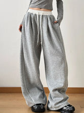 Drawstring wide leg pants in gray heathered fabric with white elastic waistband and matching drawstring details