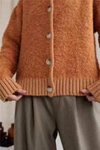 Orange fuzzy long sleeve cardigan with collared neck button front