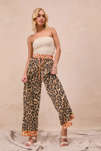 Bibi leopard print wide-leg pants with orange trim and drawstring waistband in leopard print fabric