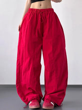 Red drawstring wide leg pants with elastic waistband made of soft fabric for comfortable wear