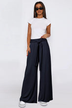 Navy blue tied wide leg pants with pockets and adjustable waistband in a comfortable wide leg design