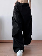 Black wide leg oversized cargo pants with relaxed fit and visible side pockets designed for versatile wear