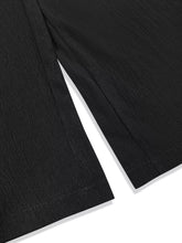 Plus size high waist wide leg pants in black textured fabric with smocked waist and precise hem stitching