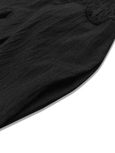 Black textured fabric with subtle embroidery on plus size high waist wide leg pants featuring a smocked waist