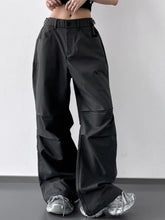 Black wide leg cargo pants with relaxed tapered fit and visible stitching details on leg cargo pants design