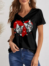Woman in FAM-FAM short sleeve cat V-neck T-shirt with tabby kittens heart, jeans