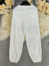 White cotton elastic waist pants with elastic waistband and cuffed ankles machine wash cold for easy care