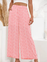 Pink and white polka dot wide leg pants with a relaxed fit perfect for casual and stylish wear
